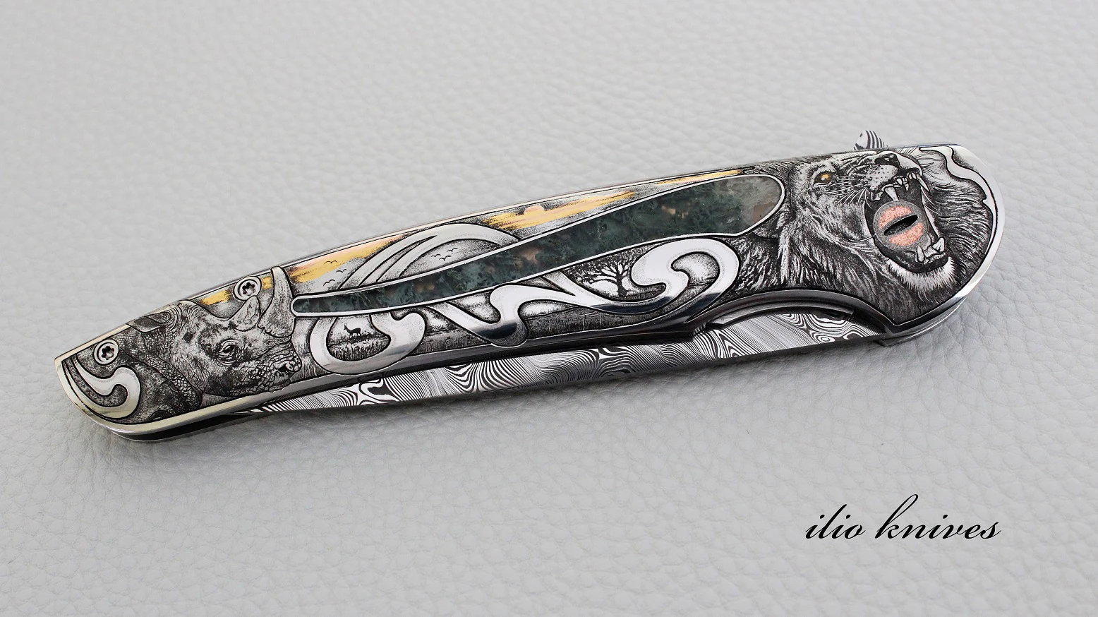 Closed Big Five knife showing rhinoceros and lion bulino engraving