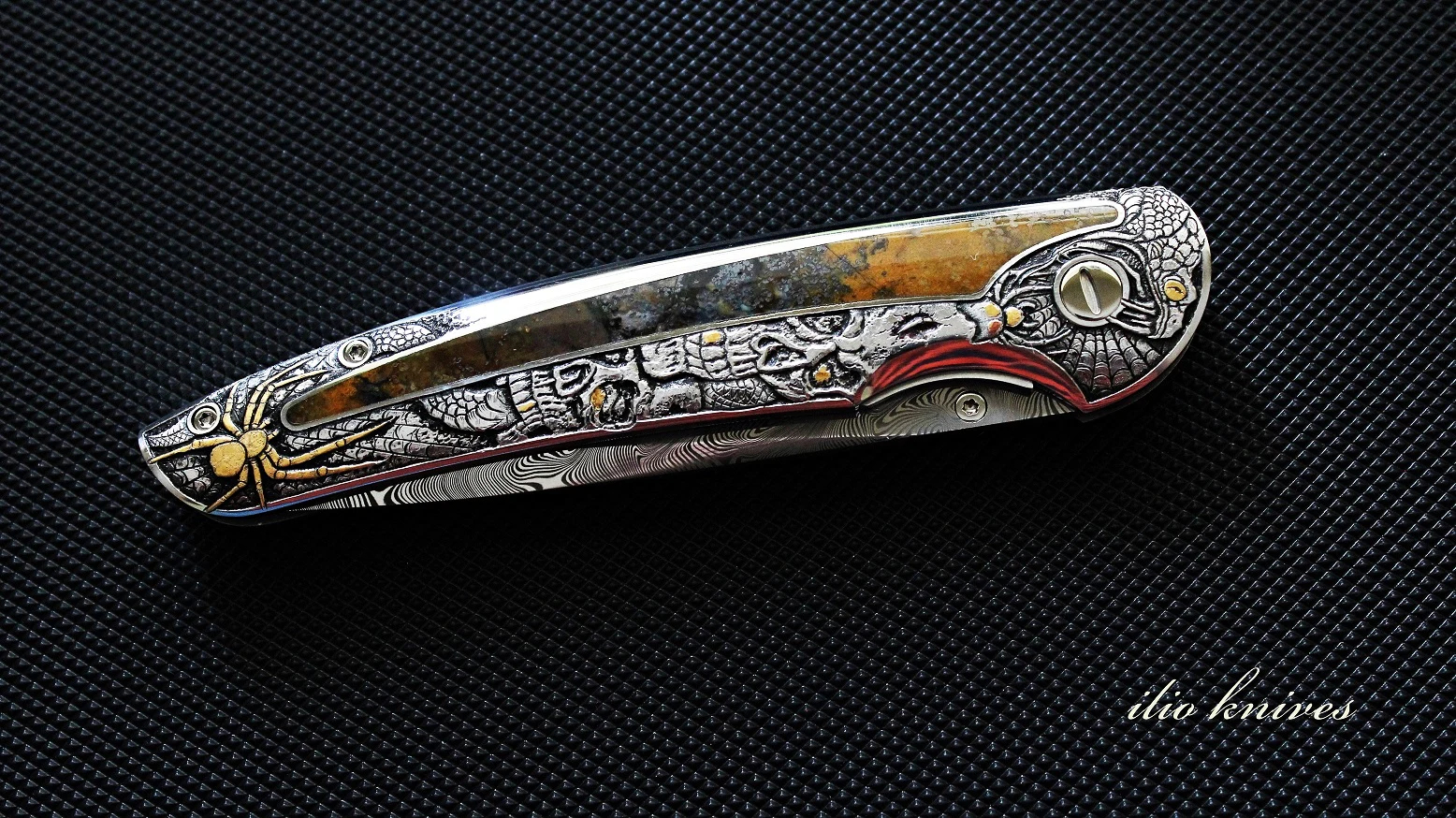 Closed Memento Mori knife showing skulls, web and gold spider engraving