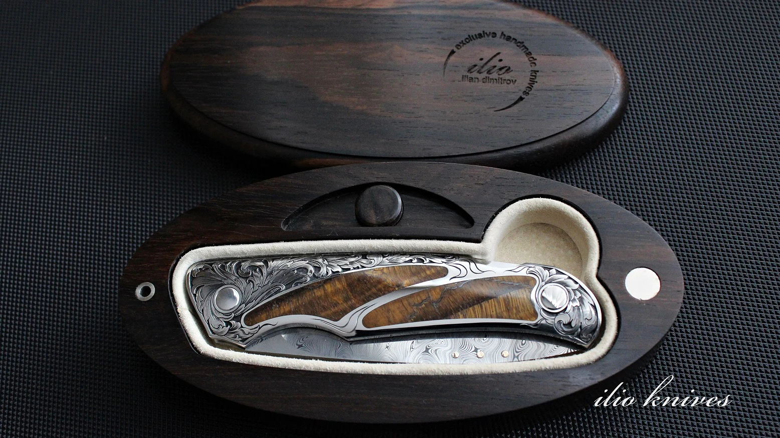 Damasteel and Tiger Eye knife folded inside a ziricote presentation box