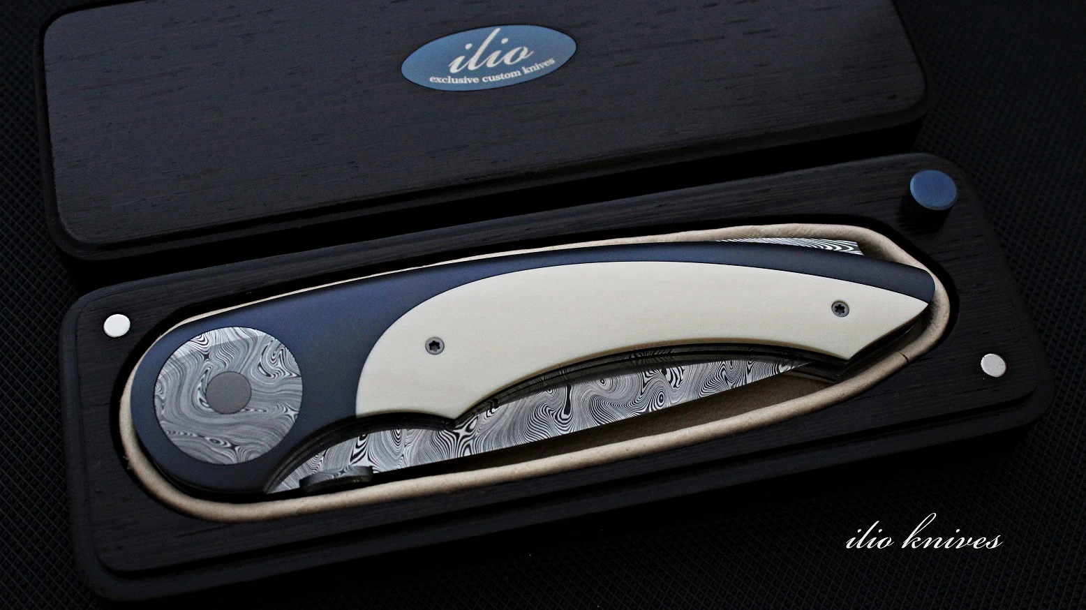 Titanium and Damasteel knife folded inside its fitted presentation box